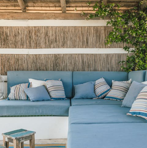Spend balmy evenings relaxing on the huge outdoor sofa area, sipping on drinks, chatting, and enjoying the view