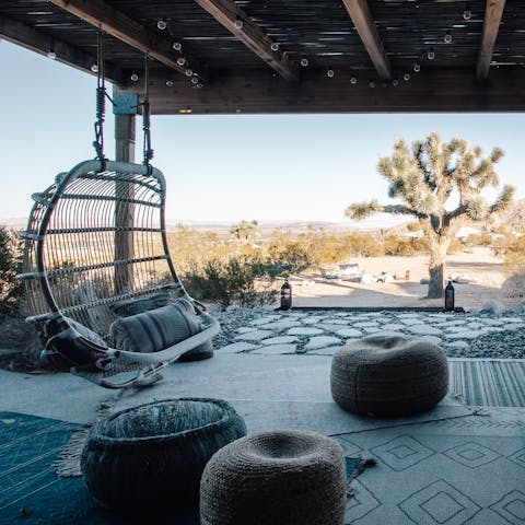 Sip a cocktail in the hanging chair as the sun goes down