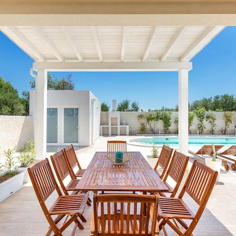 Sit down for an alfresco lunch and a bottle of Italian wine on your covered terrace