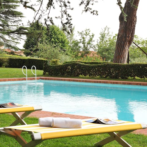 Swim laps in the pool to cool off from the Tuscan sun