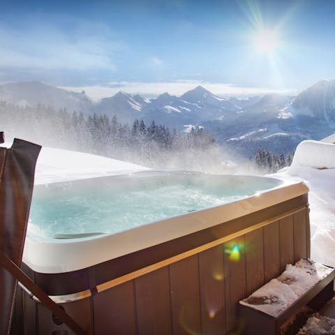 Soak in the hot tub with views across the mountains