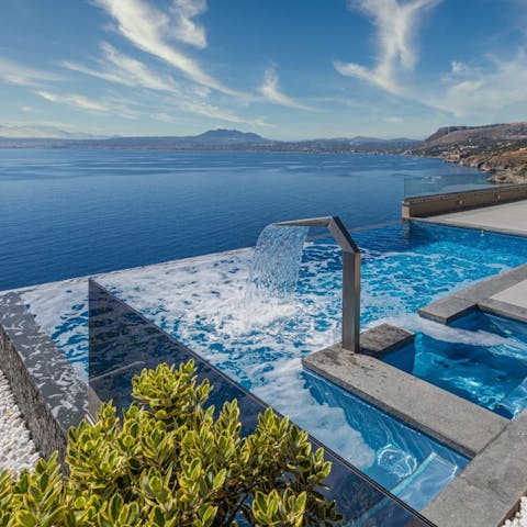 Stand under the pool waterfall and take in the stunning panoramic sea views that surround you