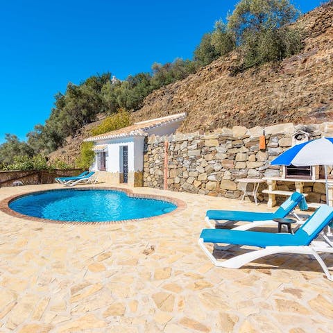 Spend days out by the crystalline pool, sunbathing on the loungers
