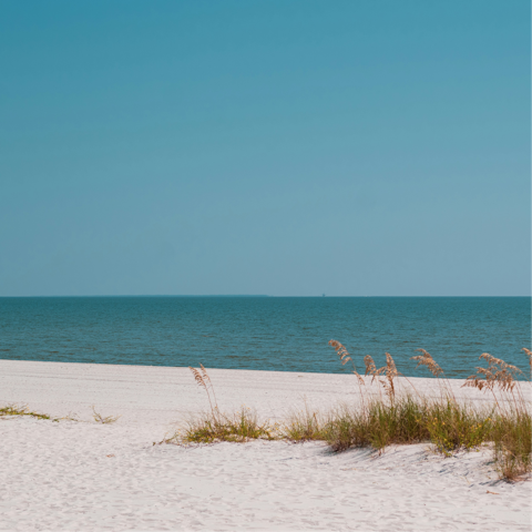Sink your toes into the sand of Seaside Beach, a short walk away
