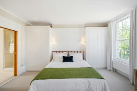 Sleep well in a serene bedroom with peaceful garden views