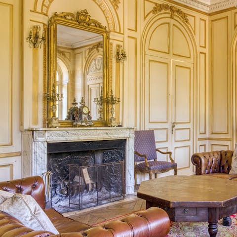 Warm up by the carved marble fireplace