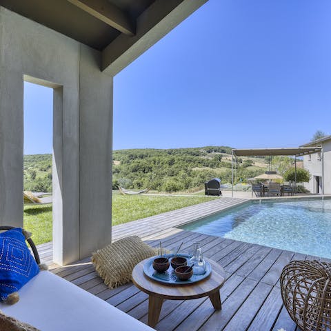 Unwind in the shade on the private pool deck, overlooking hilly hiking trails