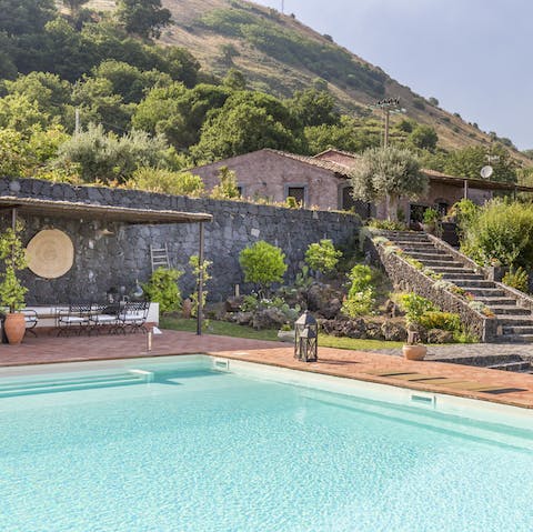 Soak up the sun by the pool or go for a swim as you gaze up at the stunning Mount Etna