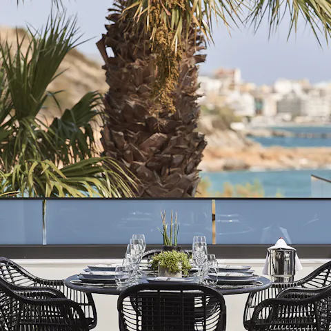 Dine alfresco beneath the shade of the palm trees