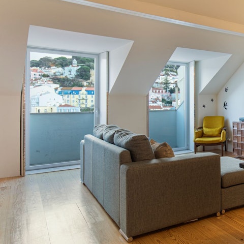 Sip vinho verde on the sofa by the huge windows