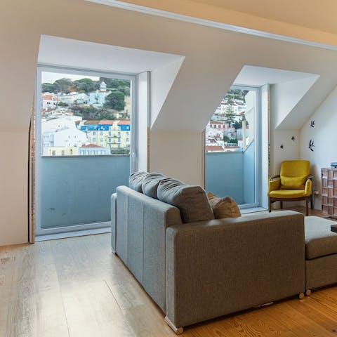 Sip vinho verde on the sofa by the huge windows