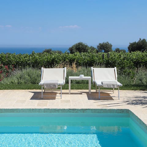 Catch some sun on the day beds around the pool