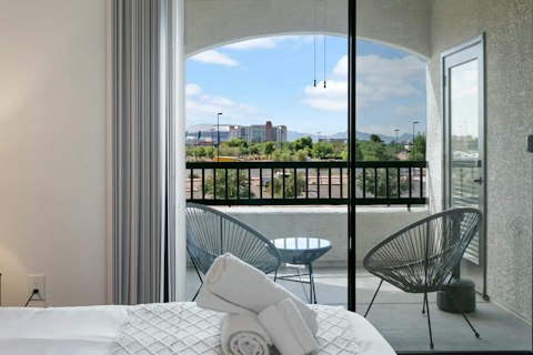 Wake to mountain and city views from the bedroom balcony