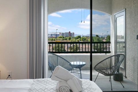 Wake to mountain and city views from the bedroom balcony