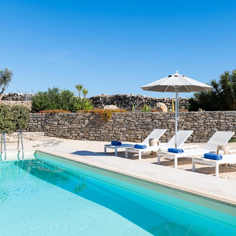 Jump into the pool before drying off in the sun with a book and a beer