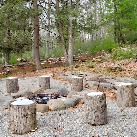 Toast marshmallows around the fire pit as night falls