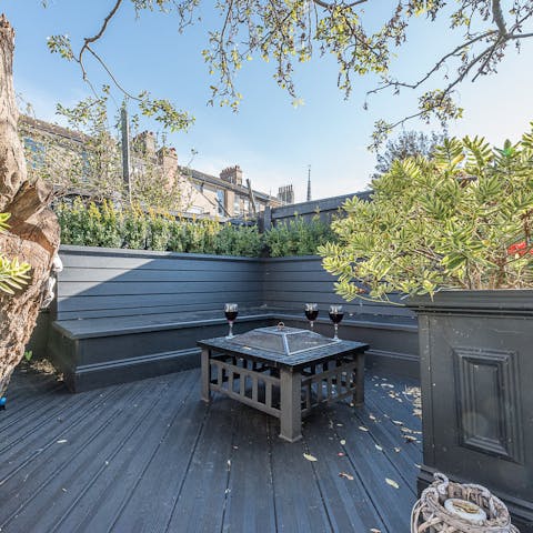 Bask in the sunshine on the garden's raised seating area and think about lighting the barbecue