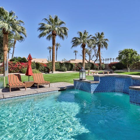 Swim laps in the waterfall-fed swimming pool