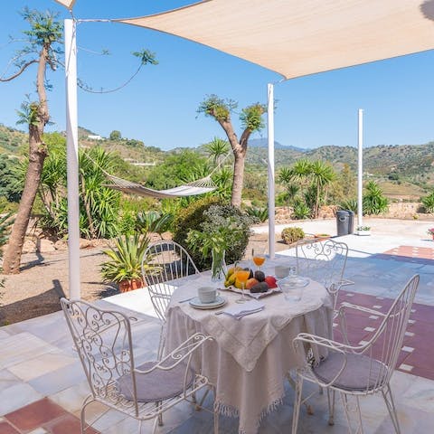 Sit down for plates of tapas and paella on the outdoor table