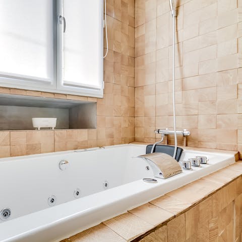 Relax sore muscles in the jacuzzi tub, setting the lights according to your mood