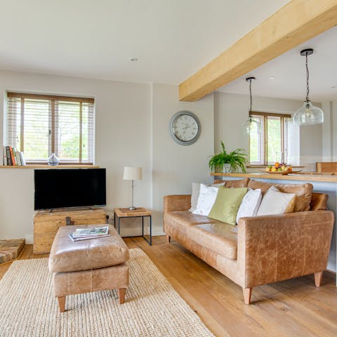 Snuggle up on the plush leather sofa for a movie night in front of the fire