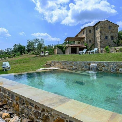 Take a refreshing dip in the pool, complete with a waterfall feature