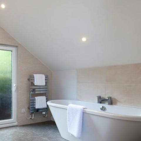 Unwind after a coastal hike with a soak in the freestanding bathtub