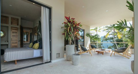Step out from the bedroom onto a palm-fringed terrace