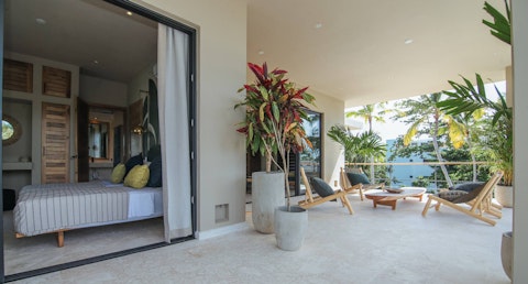 Step out from the bedroom onto a palm-fringed terrace