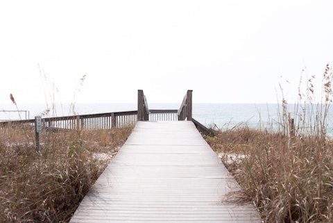 Traverse elevated boardwalks weaving through the Gulf Coast's dramatic coastal dunes