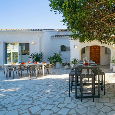 Tuck into a tasty paella all together around one of two alfresco dining setups
