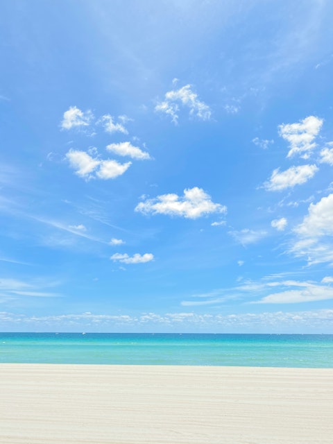 Bask on the iconic white sands of Sunny Isles Beach, a twelve-minute drive away