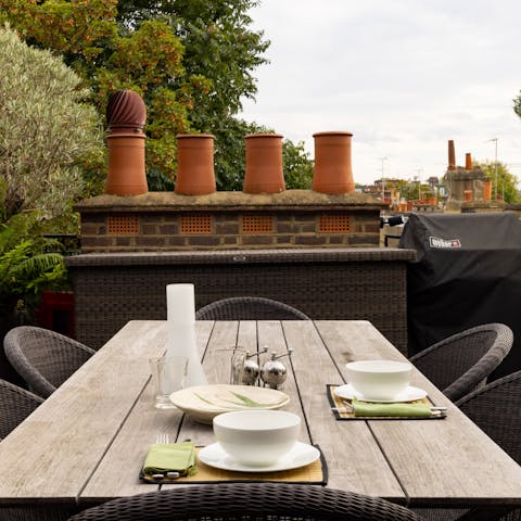 Dine on the terrace surrounded by plants and West London chimney-tops
