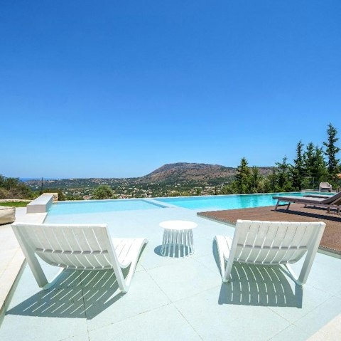 Stretch out by the pool with views of the ocean