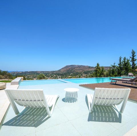 Stretch out by the pool with views of the ocean
