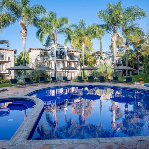 Enjoy a dip in the palm-fringed, shared swimming pool