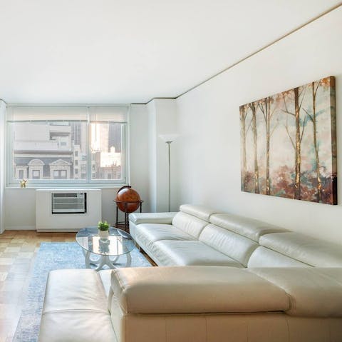 Get comfy on the white L-shaped sofa after a day exploring