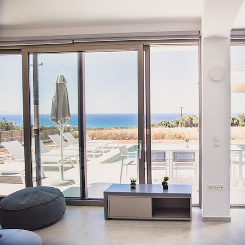 Relax indoors and let sunlight flood into the home through floor-to-ceiling windows