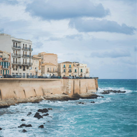 Take a scenic drive to bustling Syracusa, where you can walk along the waterfront