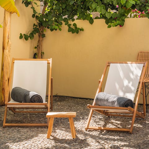 Relax on a deckchair with a glass of something chilled in hand