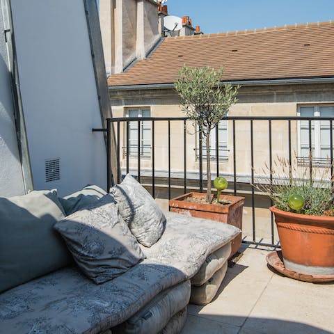 Kick back on the outdoor sofa and watch the sunset over the rooftops