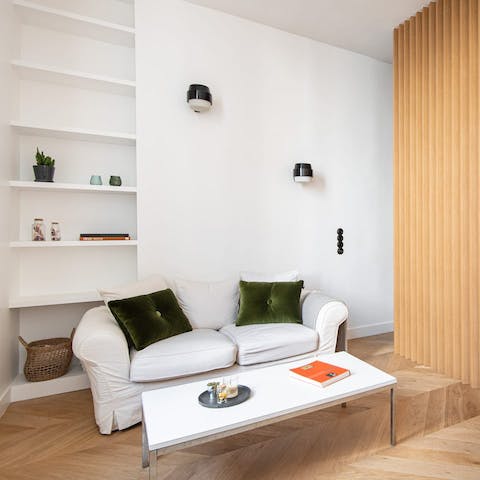 Enjoy a glass of Champagne and plan your Paris adventure from the comfy sofa