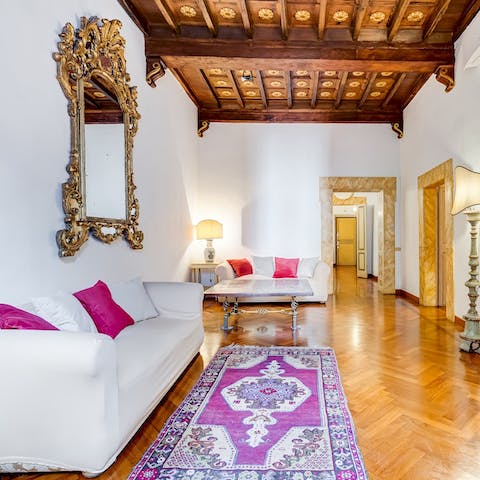 Relax in the living room beneath a beautiful coffered ceiling
