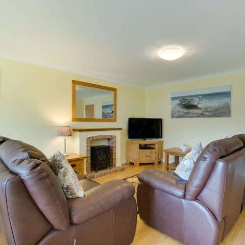 Kick back by the electric fire with a glass of wine