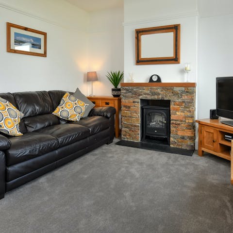 Cosy up in the second sitting room with the stove on the go