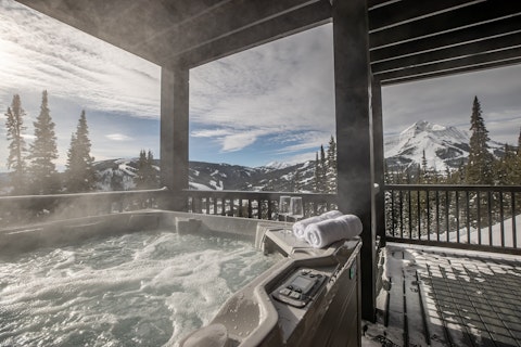Soak in the hot tub while snow-capped peaks stretch ahead