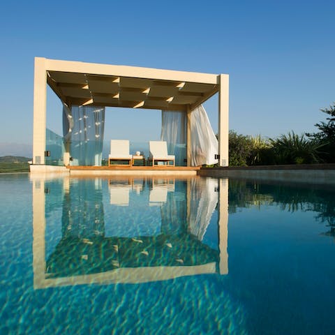 Savour slow mornings in Crete as you lounge beneath the poolside pergola