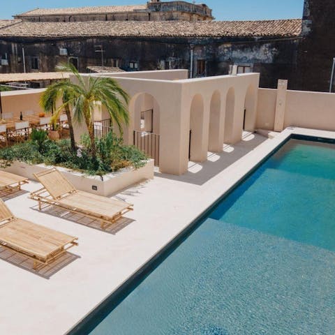 Soak up the sun by the rooftop pool