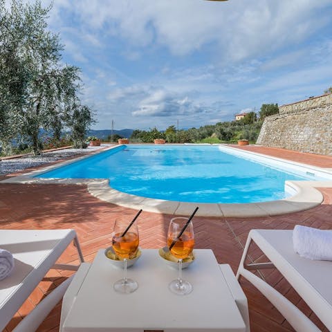 Enjoy a glass of Prosecco by the pool in the Italian sun