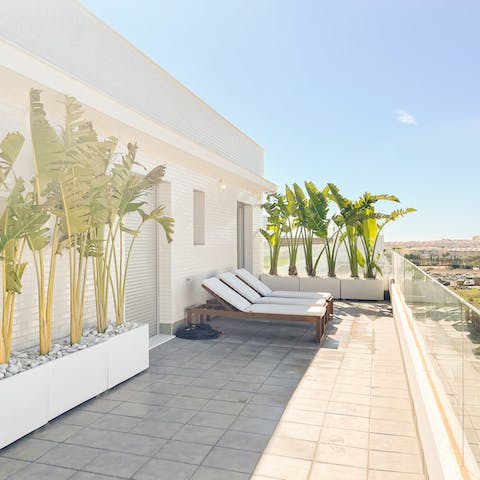Relax on the private balcony surrounded by palms